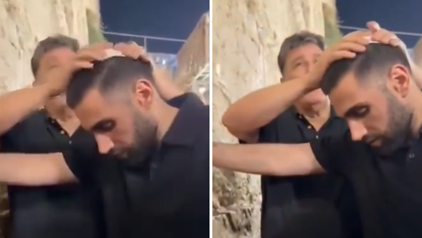 Former hostage Segev Kalfon prays at Western Wall with father