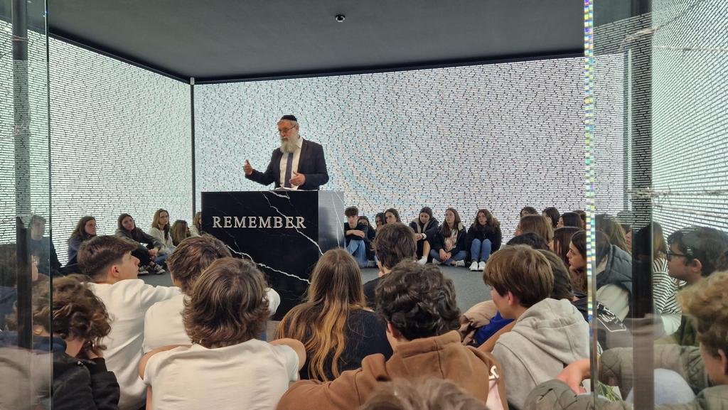 Teenagers from Portuguese schools listen to the Chief Rabbi of Oporto at the Name Room of the Holocaust Museum